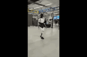 elon musk optimus tesla robotic blurry cellphone 2...